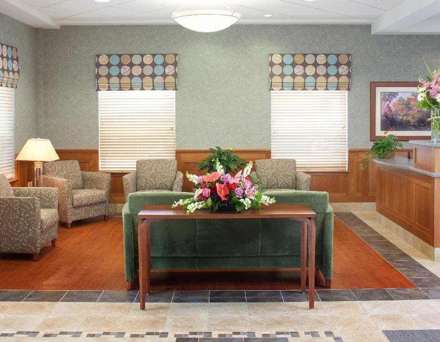 A welcoming lobby with comfortable seating and a table with a floral arrangement.