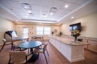 A modern kitchen and dining area with stylish furnishings and bright lighting.