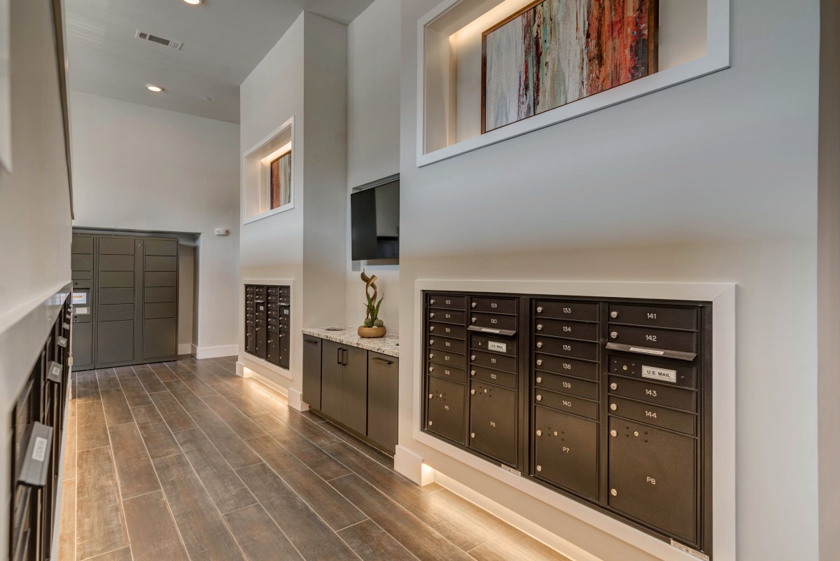 A modern building lobby featuring sleek mailboxes and contemporary decor.