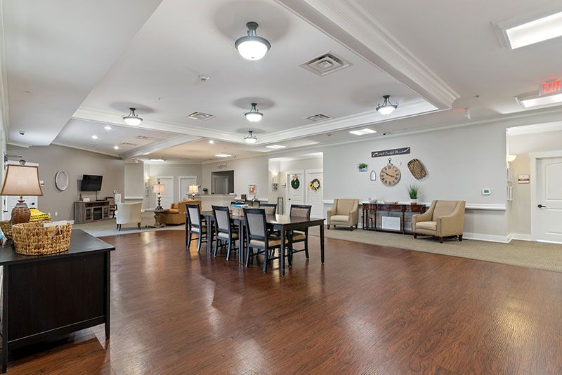 Spacious and well-lit interior living space with a combined dining area, featuring elegant furniture and decor.