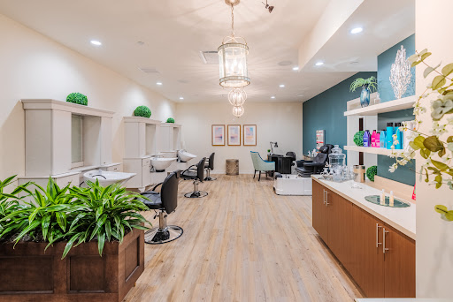 A modern and stylish hair salon featuring elegant lighting and contemporary decor.