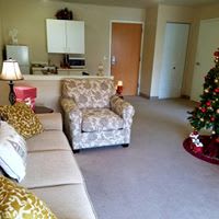 A cozy living room with festive Christmas decorations.