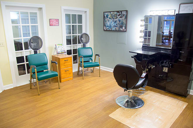 A cozy hair salon interior with styling and drying stations.