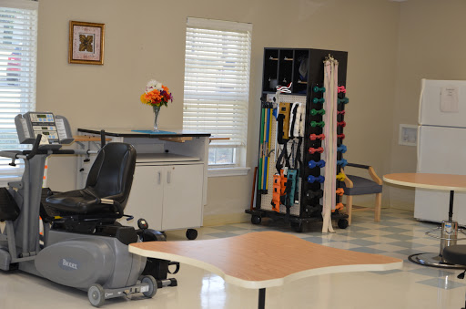 A therapy room equipped with rehabilitation tools and a mobility aid, designed for physical recovery.
