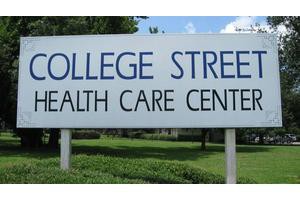 A sign for College Street Health Care Center outdoors.