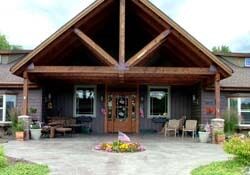 A rustic cabin with a wooden facade and outdoor seating area.