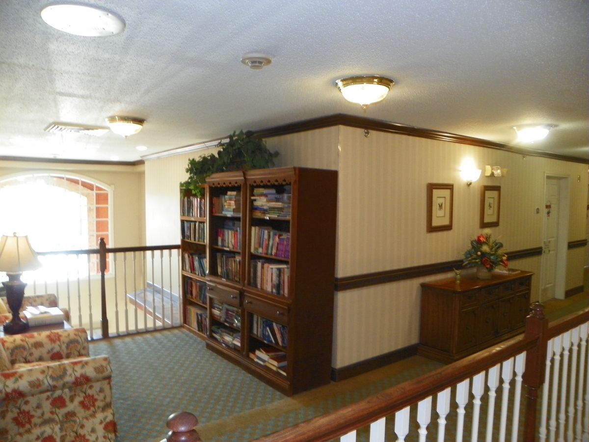 A cozy hallway with bookshelves and comfortable seating.