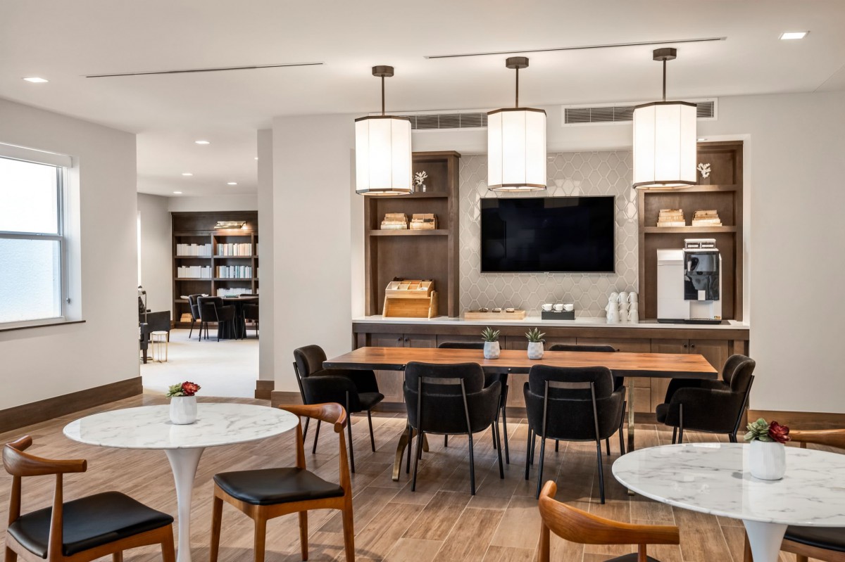 A modern lounge area with stylish furniture and lighting.