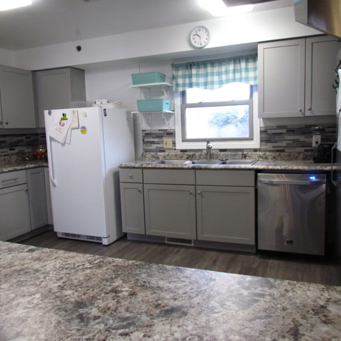 A kitchen interior featuring appliances and cabinetry.