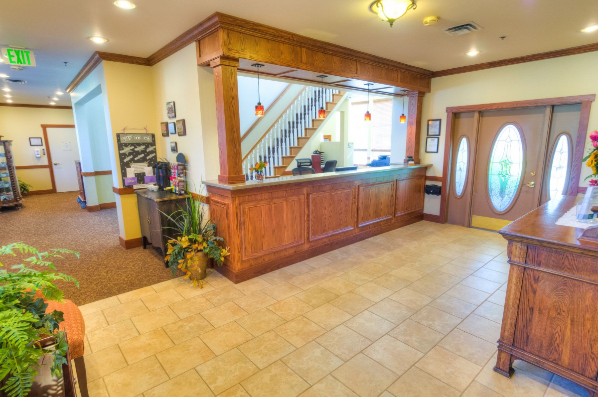 A hotel lobby with a reception desk and entrance area.
