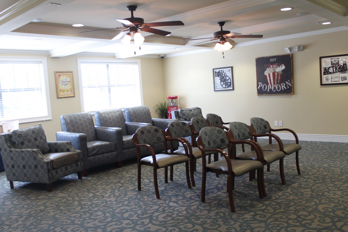 A waiting room with arranged seating and ceiling fans.