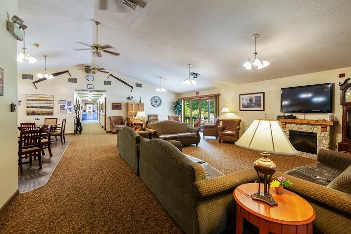 A spacious living room with comfortable seating, warm lighting, and a cozy atmosphere.
