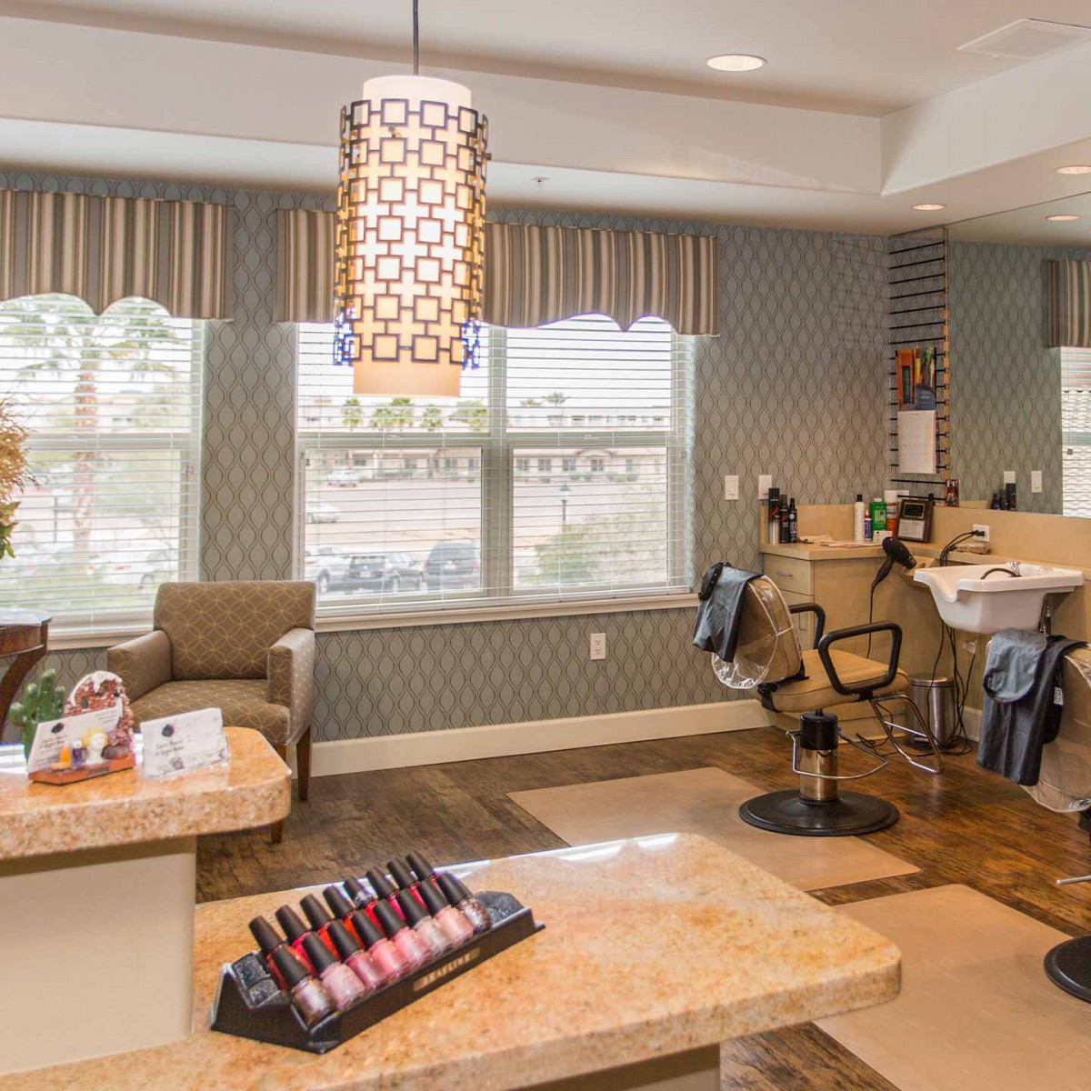 A modern salon interior with comfortable seating and a display of nail polishes.