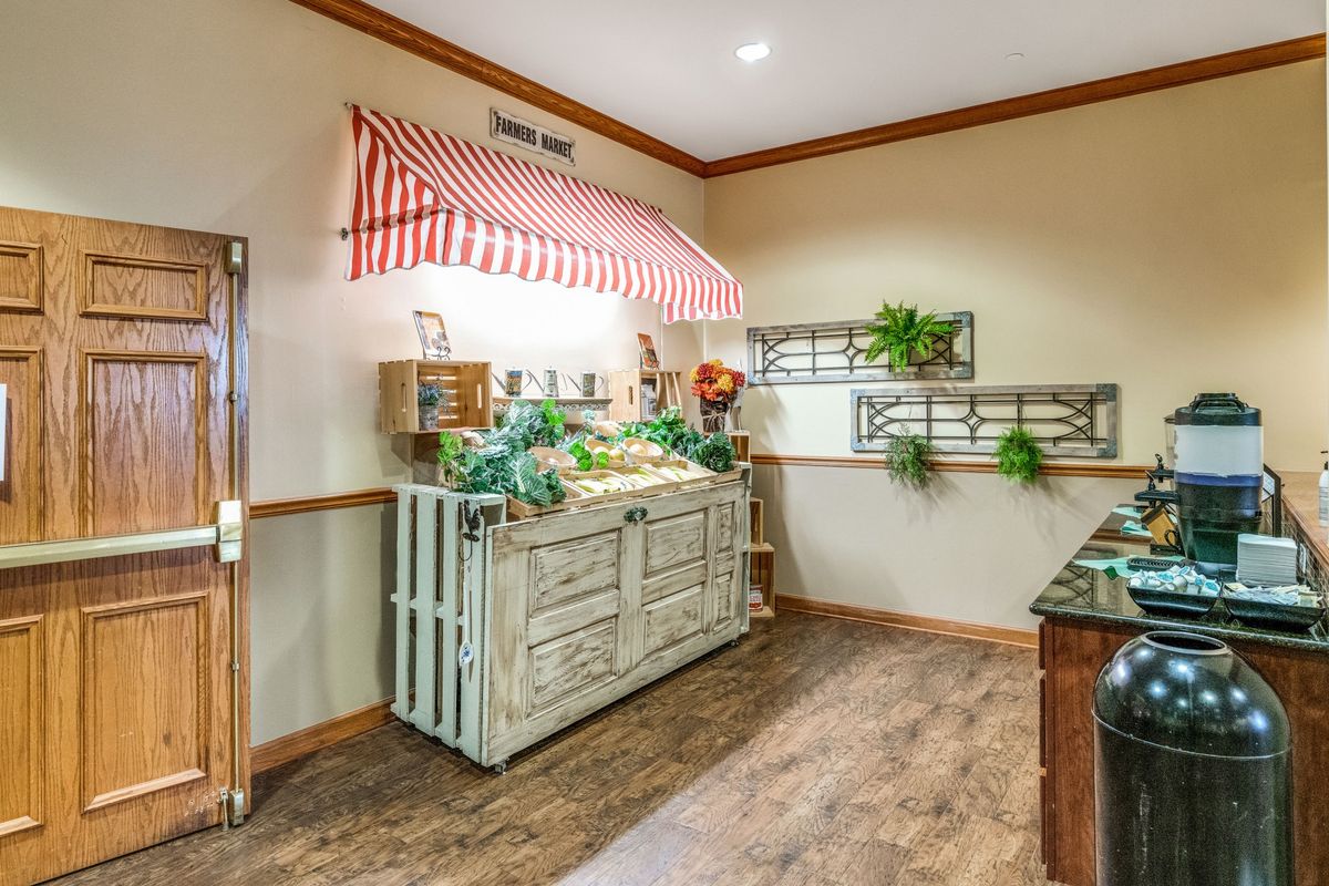 A rustic kitchen interior featuring a countertop with plants and decorative accents.