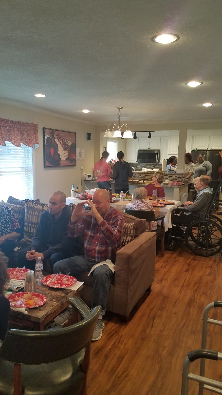 A group of people enjoying a meal together in a cozy living room setting.