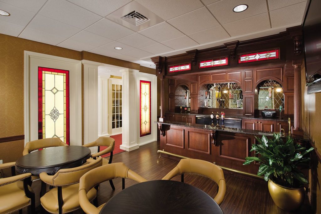 An elegant bar area featuring wooden furniture and cozy seating arrangements.