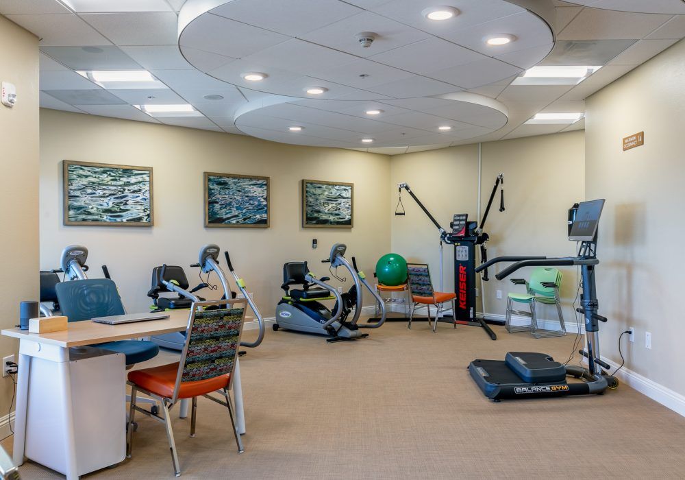 A well-equipped indoor gym with various exercise machines and workout equipment.