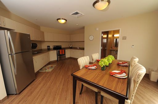 A spacious and modern kitchen with an inviting dining area, featuring a stylish table setting.