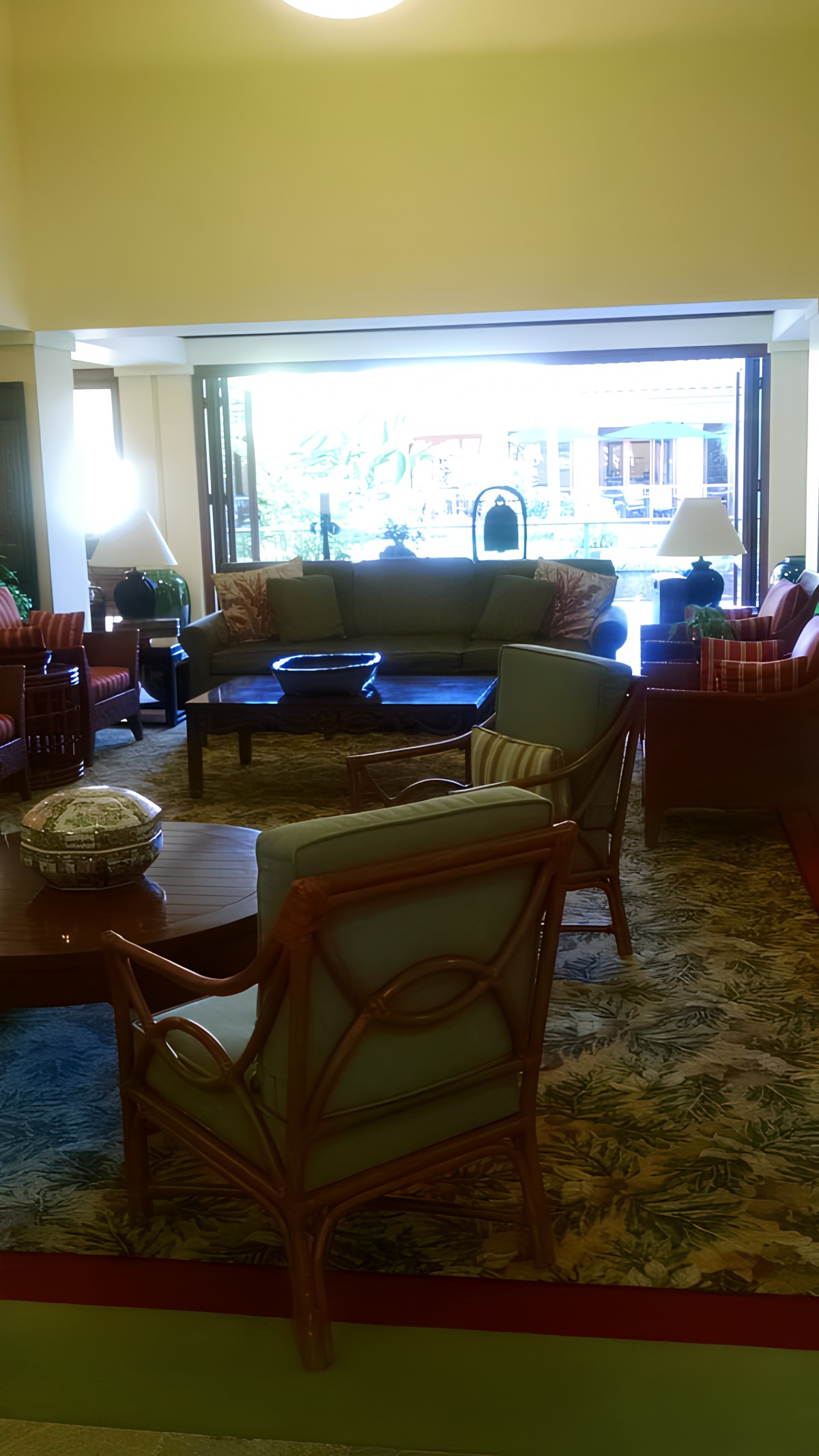 A cozy lounge area with comfortable seating and large windows.