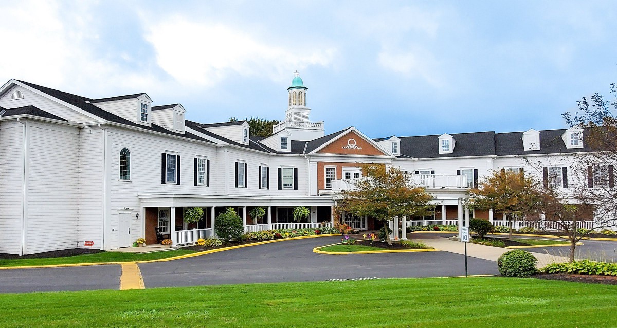 A scenic exterior view of a hotel or resort with elegant architecture and well-maintained landscaping.