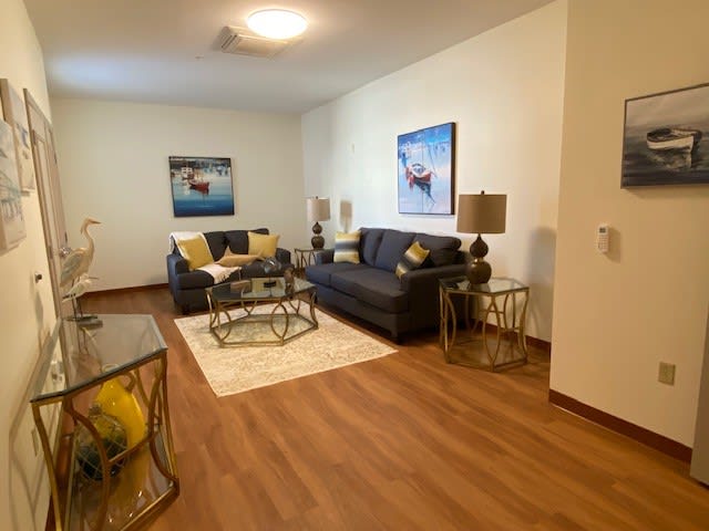 A modern living room with comfortable sofas, stylish coffee tables, and decorative artwork.