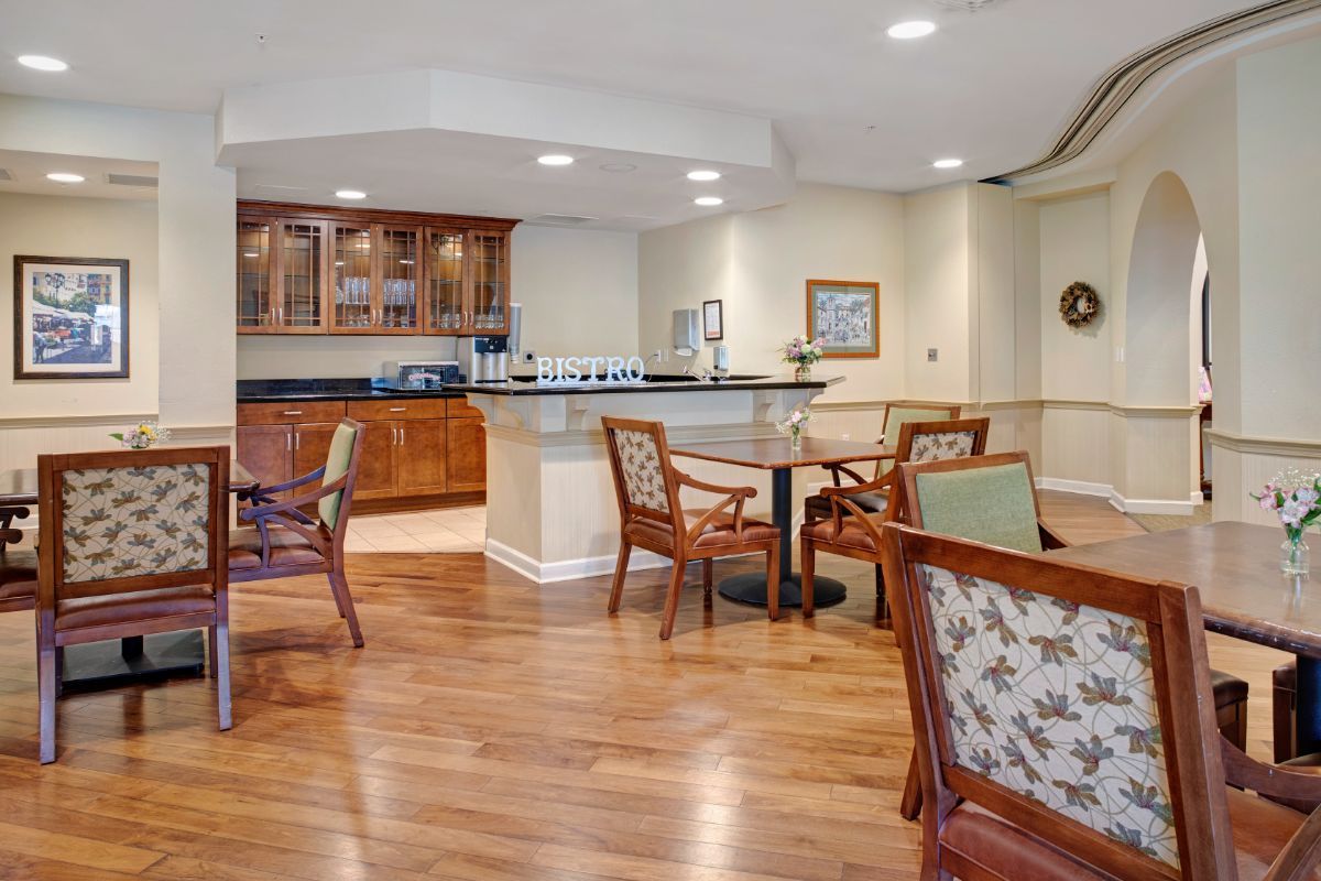 A cozy dining area with wooden floors, elegant furniture, and a bar counter.