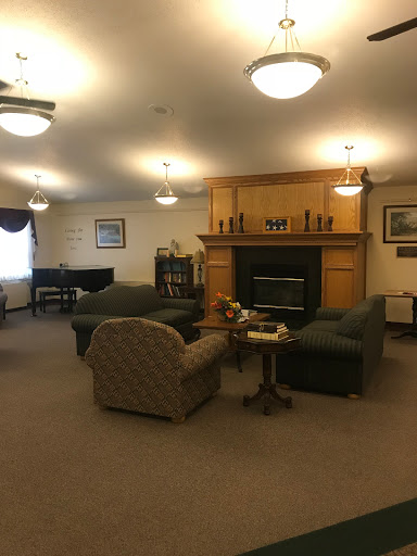 A cozy living room setup featuring comfortable seating and a warm fireplace.