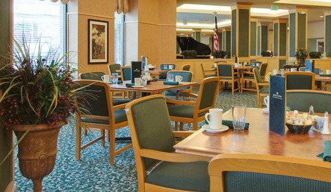 A cozy cafe interior with neatly arranged tables and chairs, creating a welcoming and relaxing atmosphere.