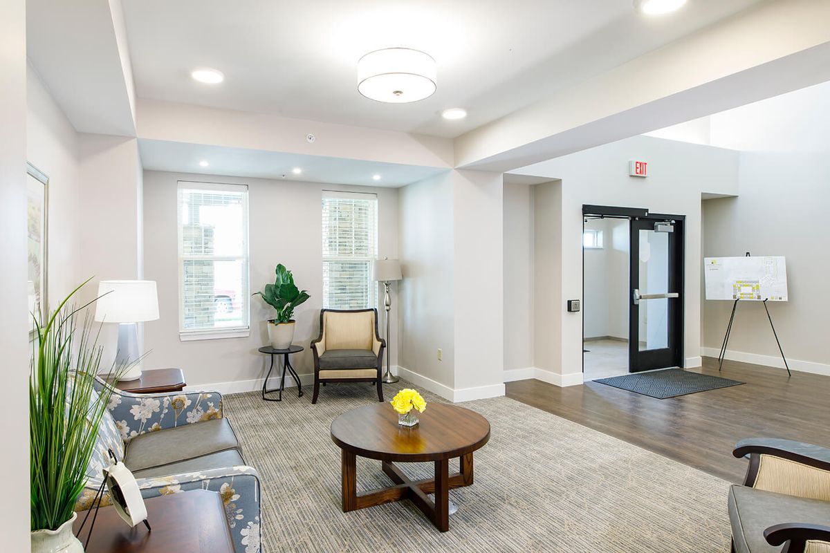 A cozy and well-lit living room with comfortable seating and modern decor.