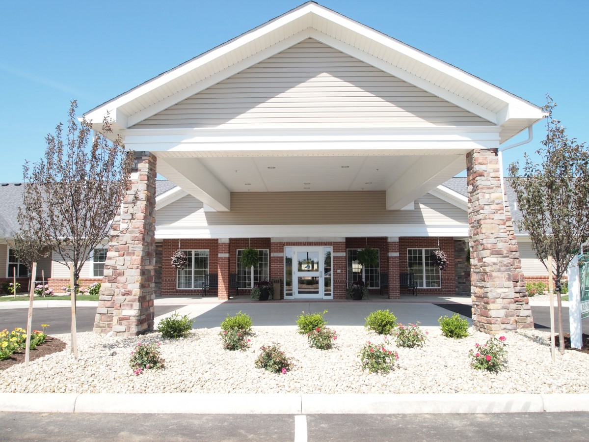 The front entrance of a commercial building with landscaped surroundings.