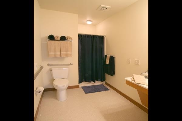 A minimalist bathroom with essential amenities and a tidy arrangement.