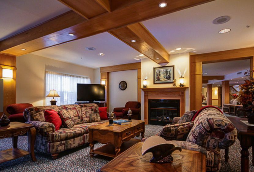 A cozy living room with a television, fireplace, and comfortable seating.