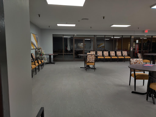 A spacious and empty waiting room featuring modern seating arrangements and a well-lit environment.