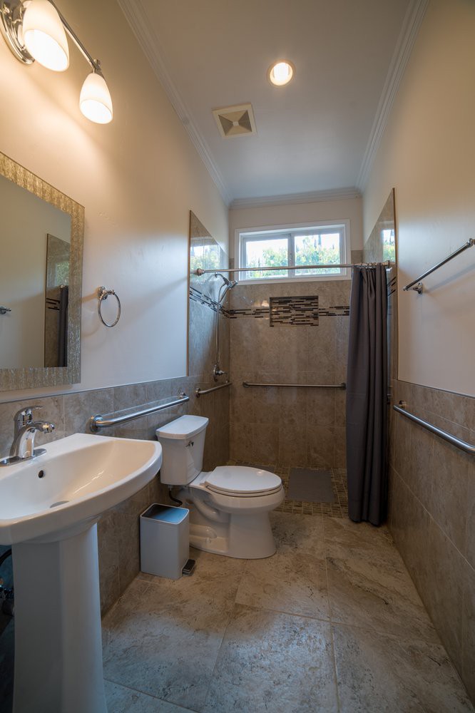 A well-lit bathroom featuring a sink, toilet, and shower area with modern fixtures.