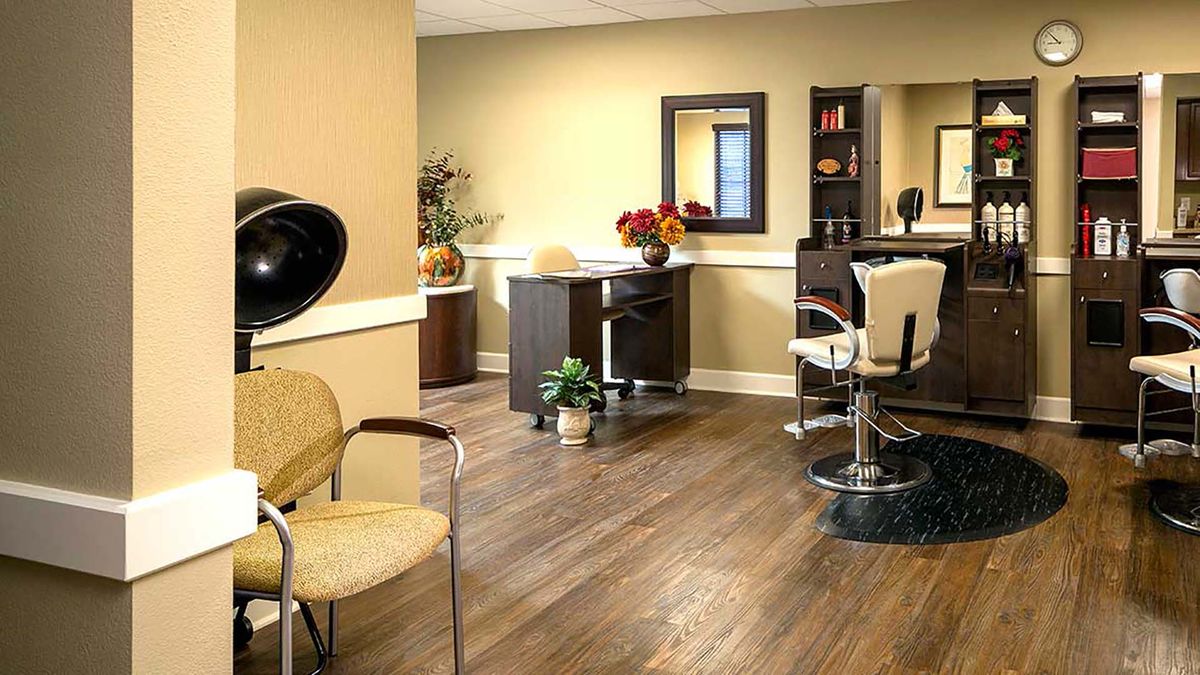 A modern hair salon interior with styling chairs, mirrors, and a hairdryer.