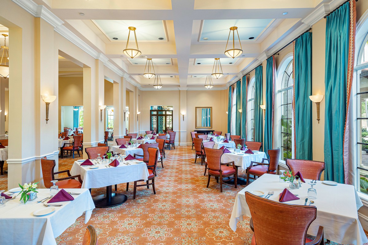Elegant dining room with beautifully set tables and warm lighting.