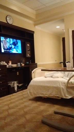 A view of a hospital patient room featuring a bed and television.