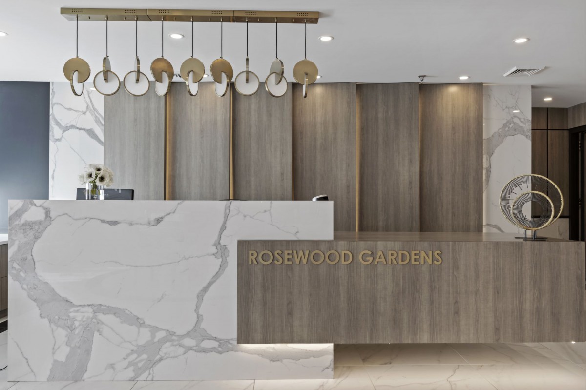 A modern and luxurious reception area with a marble counter and elegant lighting.