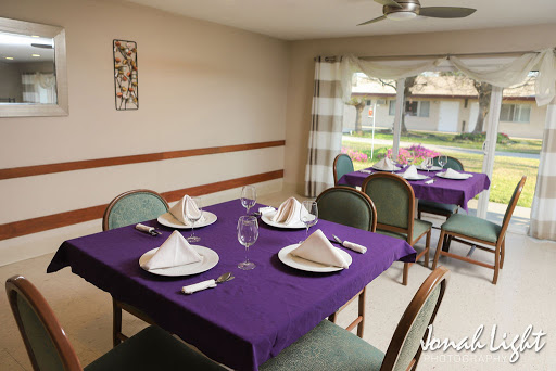 A cozy dining area arranged for a meal with elegant purple accents.