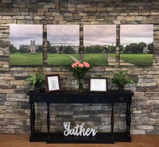 A beautifully arranged interior showcasing landscape photography, complemented by fresh flowers and decorative elements.
