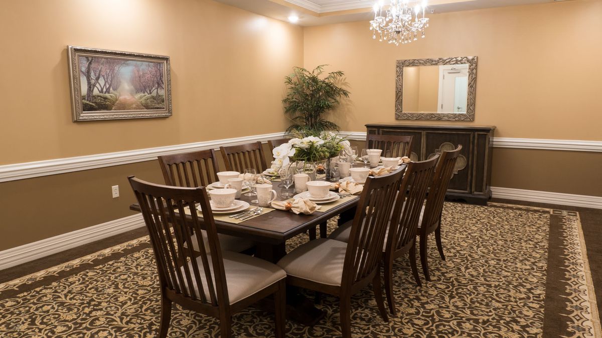 Elegant dining room setup with a large table and formal decor.