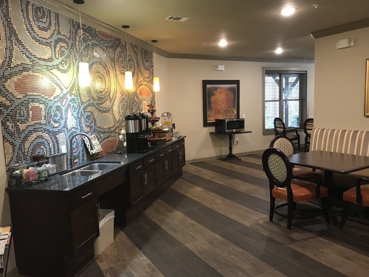 A cozy cafe interior with seating, a coffee station, and decorative elements.