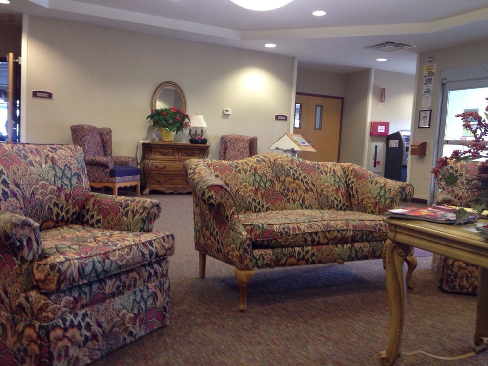 A cozy waiting room with patterned furniture and soft lighting.