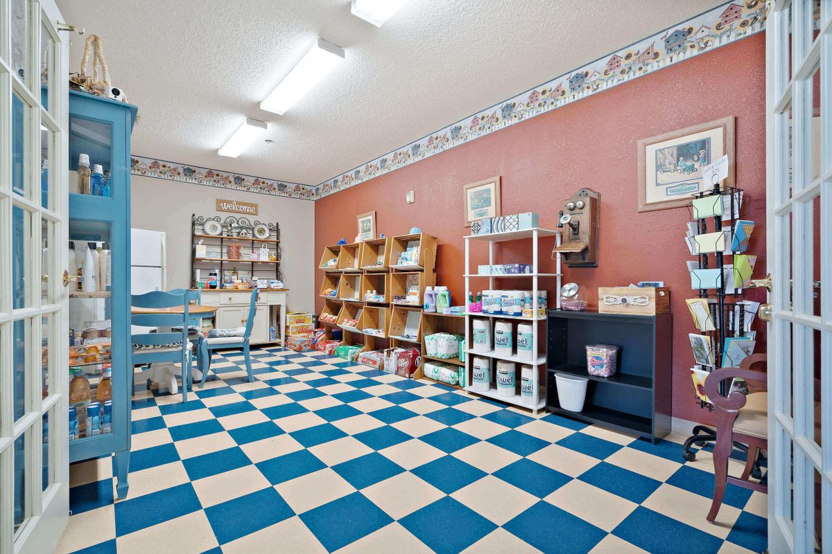 A veterinary clinic waiting room with a checkered floor and shelves.