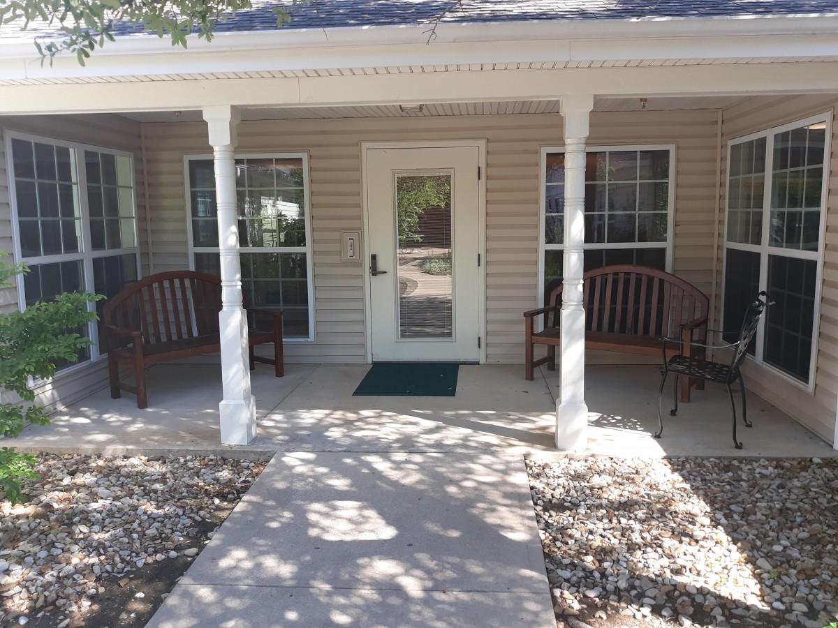 A welcoming front porch with a walkway and seating.