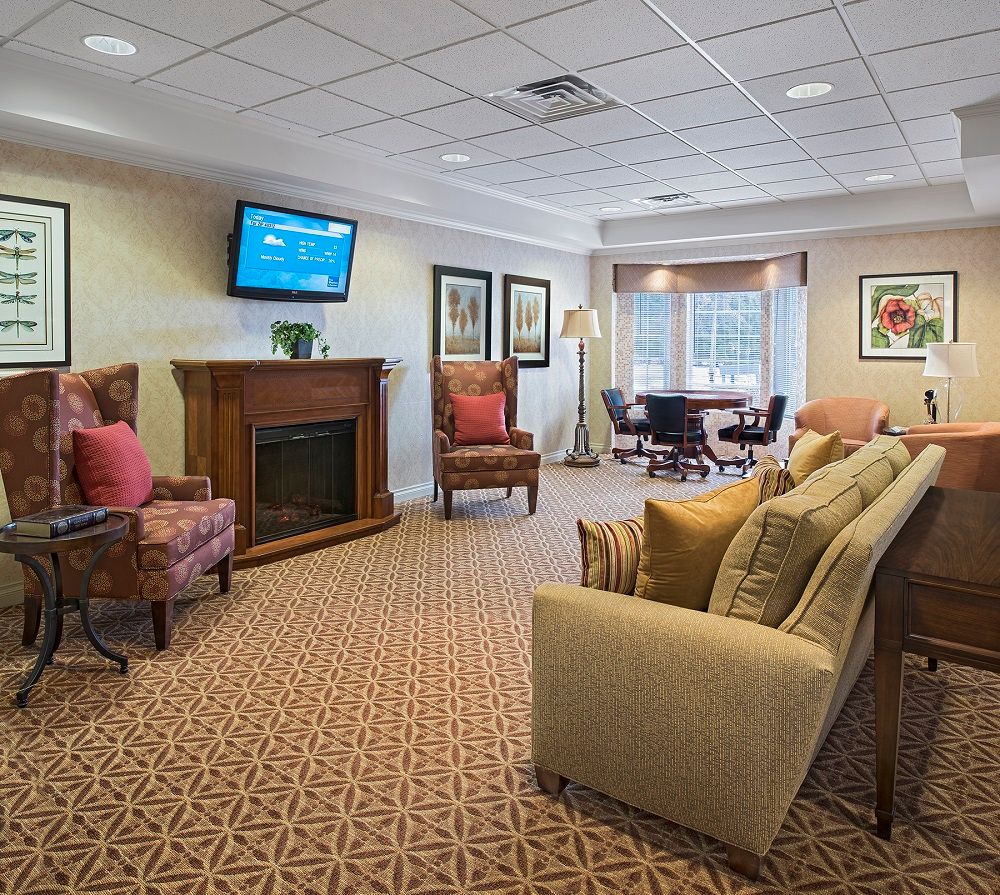 A cozy living room with comfortable seating and a fireplace.