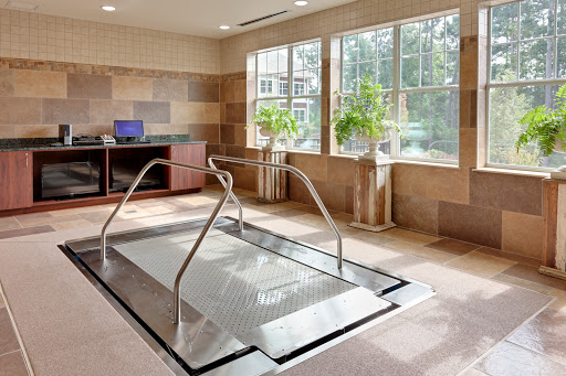 A serene indoor spa area featuring a relaxation pool surrounded by natural light.