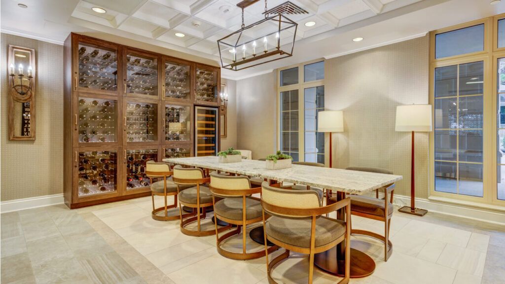 A luxurious modern dining room featuring a marble table, stylish chairs, and an elegant wine rack.