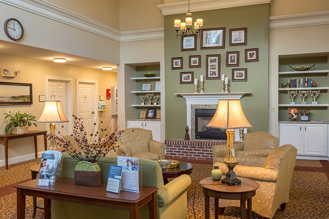 A cozy and elegantly designed living room featuring a fireplace, comfortable seating, and tasteful decor.