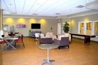 A modern lounge with comfortable seating and a television.